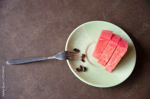 Slices of watermelon in a bowl, dark texture background
