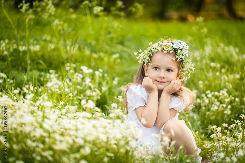 Little girl in a field with white flowers Little girl in a field with white flowers
