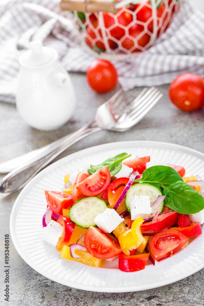 Tomato salad with fresh bell pepper, red onion and feta cheese. Healthy eating