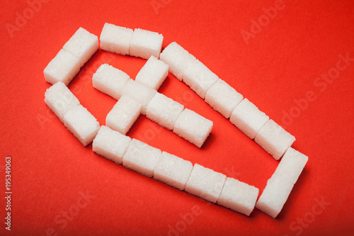 Tableau sur toile Sugar kills, a coffin made of cubes of sugar on a red background.