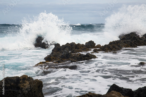 Waves Crashing Over Rocks On A Beach On The Island Of Oahu