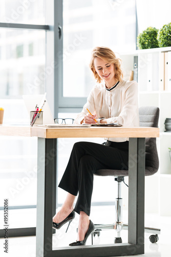 Portrait of a smiling young businesswoman working