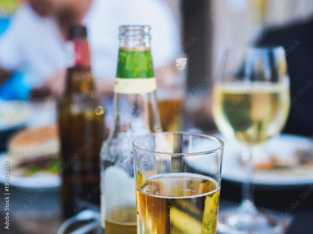 Apple cider in the glass and bottles in cafe Apple cider in the glass and bottles in cafe