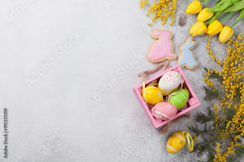 Easter eggs and yellow flowers. Greeting card