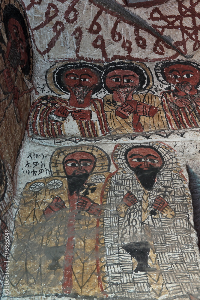 wall mural of saints and iconographic scenes, painted in naive african christian style, on church wall in Ethiopia 