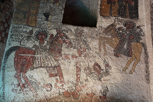 wall mural of saints and iconographic scenes, painted in naive african christian style, on church wall in Ethiopia  photo