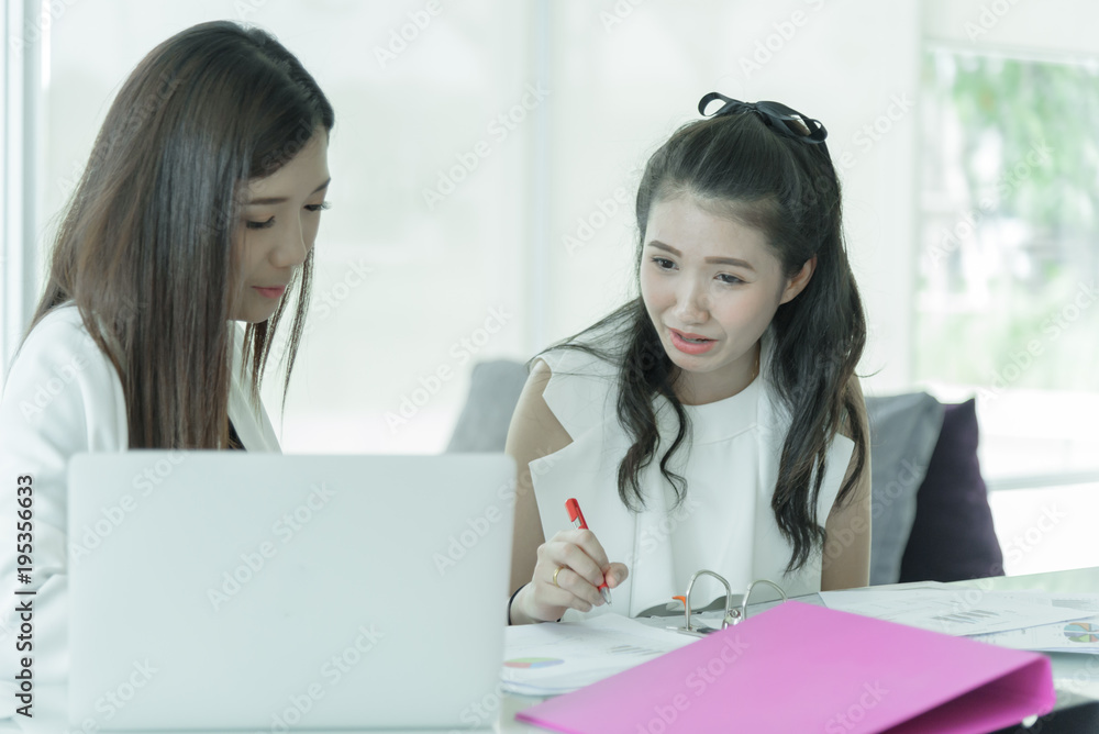 Women working together with intention and seriously in the office interior. Women working together with intention and seriously in the office interior.