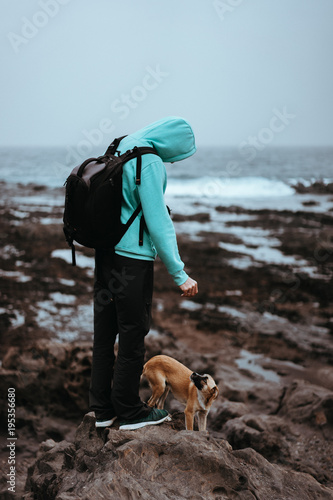 Man with a dog on stony coastline of Santo Antao Island, Cape Verde photo