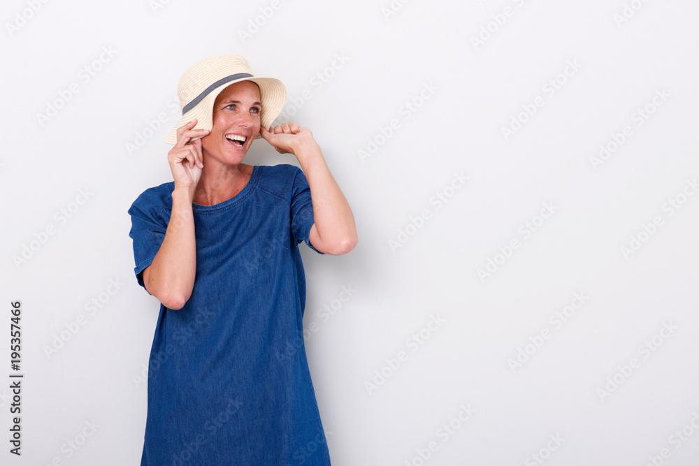 middle aged woman laughing with hat against white background middle aged woman laughing with hat against white background