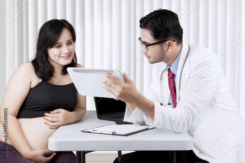 Asian pregnant woman having a consultation with a gynecologist