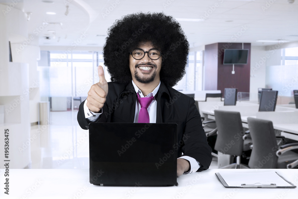 African american with laptop showing thumbs up African american with laptop showing thumbs up