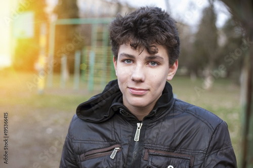 A teenager was busy with street workout. Now he is having fun with pleasure. He had a merry face, he spent all the rage on the bars