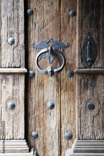 Background with wooden old Gothic door and door handle