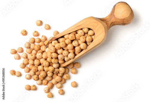 dried chickpeas in the olive wood scoop, isolated on white, top view