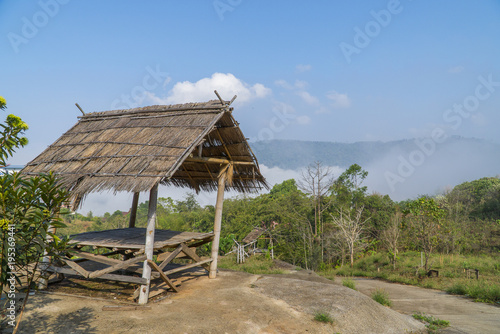 Old wooden hut on the hill and clouds