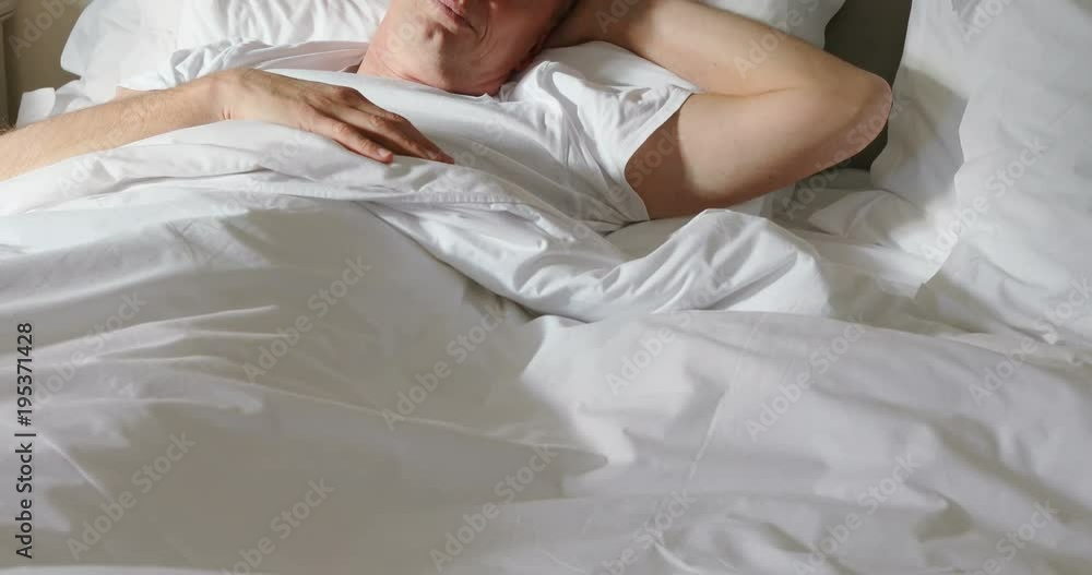 Man sleeping peacefully on bed