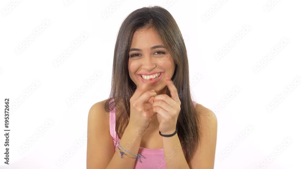 Cute beautiful young woman making funny gesture with fingers isolated slow motion Cute beautiful young woman making funny gesture with fingers isolated slow motion