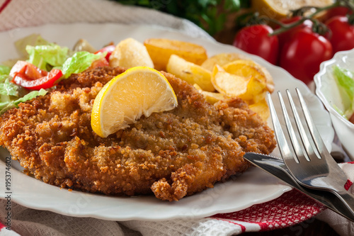 Breaded viennese schnitzel with baked potatoes