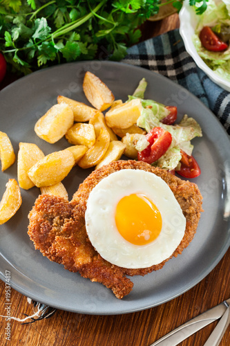 Breaded viennese schnitzel with fried agg