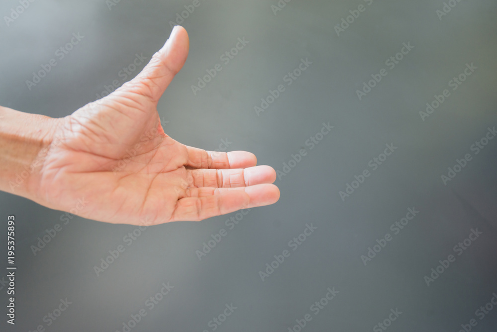 Finger gestures and wrinkled hands On a gray background Finger gestures and wrinkled hands On a gray background