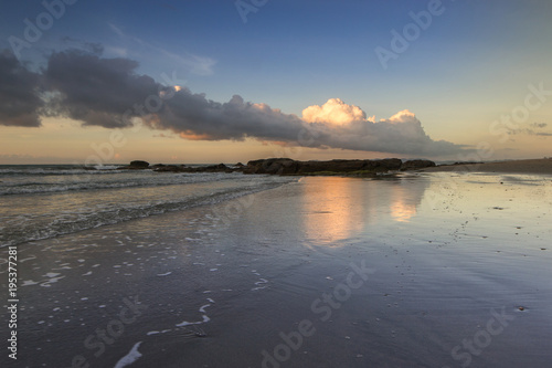 sunset seascape with beautiful clouds reflection.