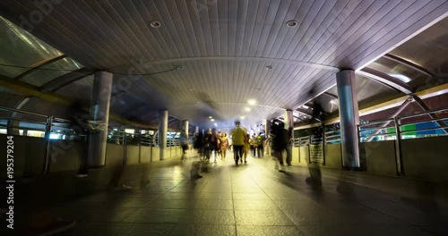 Time lapse of people commuting on a bridge at night, at Bangkok city, Thailand.