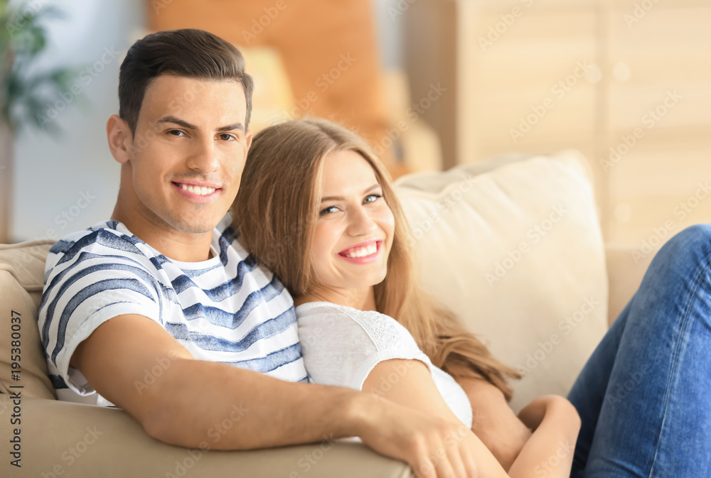 Young couple on sofa at home