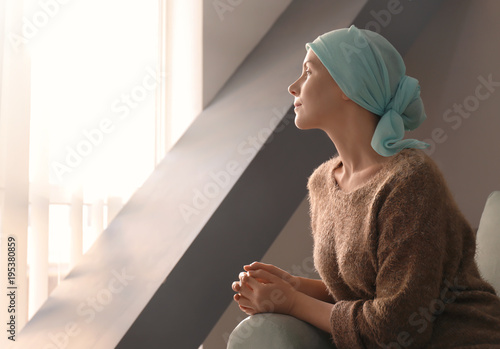 Young woman with cancer in headscarf indoors Fototapet