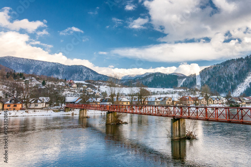 Slovak village of Nezbudska Lucka near Strecno in the winter, river The Vah with the bridge in the foreground.