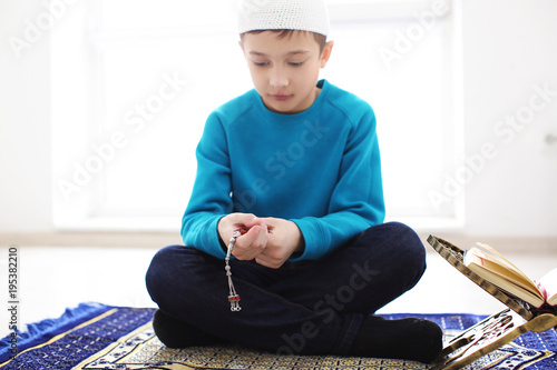 Little Muslim boy praying, ...