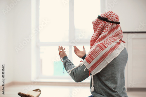 Young Muslim man praying, i...
