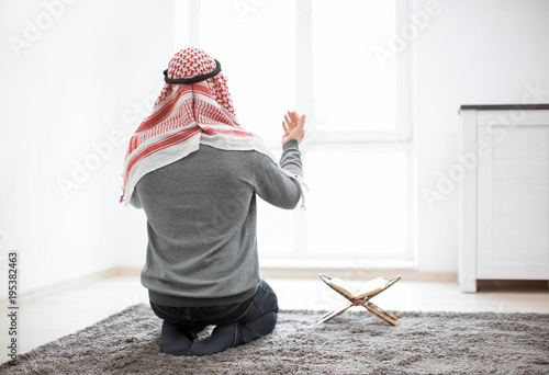 Young Muslim man praying, i...