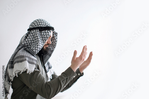 Young Muslim man praying on...