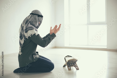 Young Muslim man praying, i...