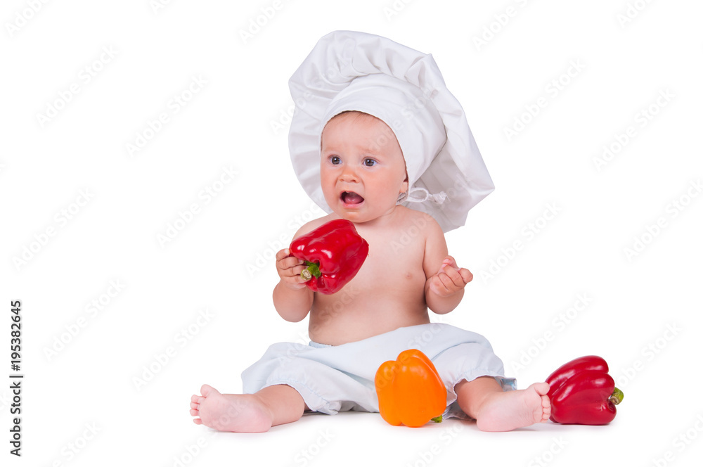 A funny little girl in a chef's clothes is eating pepper. A funny little girl in a chef's clothes is eating pepper.