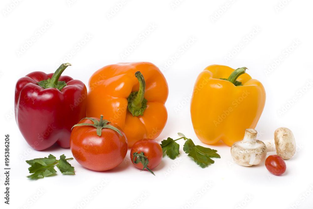 Red yellow and orange peppers on a white background..Multicolored vegetables in a composition on an abel background. Red yellow and orange peppers on a white background..Multicolored vegetables in a composition on an abel background.