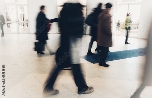 abstract crowd of anonymous blurred people walking in a shopping mall