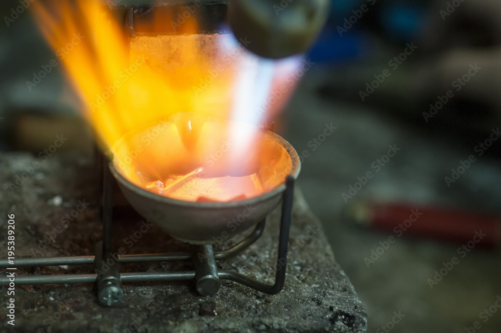 Craft jewelery making with professional tools. Macro shot. A handmade jeweler process, manufacture of jewellery. Melting metal