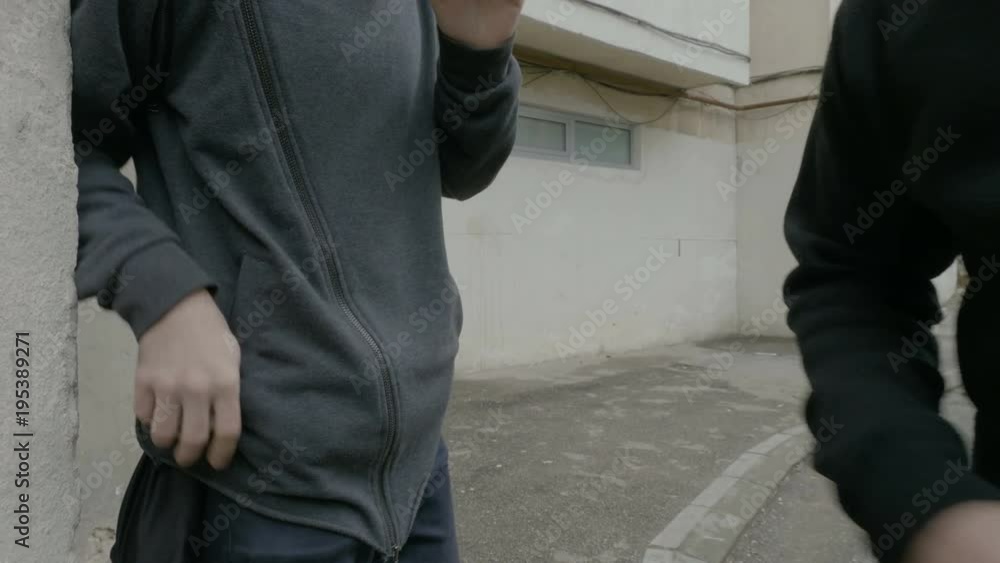 Famous male rapper buying marijuana drugs from a dealer in hood in a dangerous neighborhood during day time Famous male rapper buying marijuana drugs from a dealer in hood in a dangerous neighborhood during day time