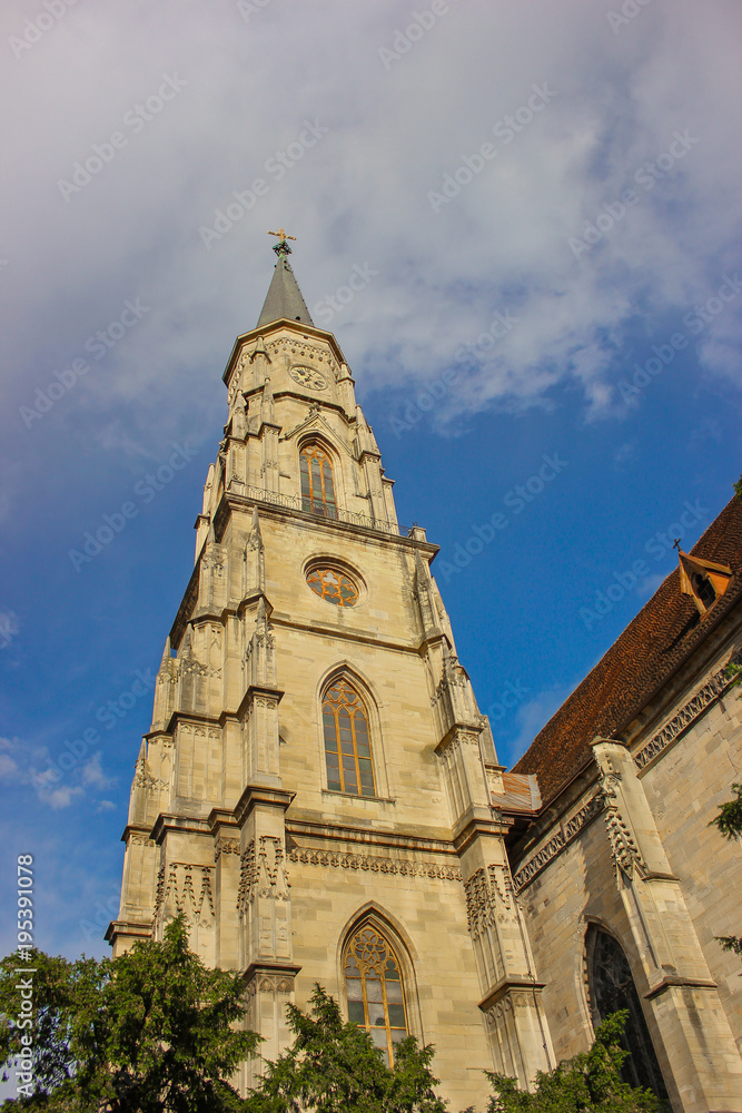 Gothic architecture of Church St. Michael in Cluj-Napoca, Romania with partly cloudy blue sky background