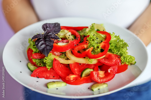 Vegetable salad of tomatoes, pepper, lettuce and sesame salad. The concept is healthy food, diet, vegetarianism, weight loss.