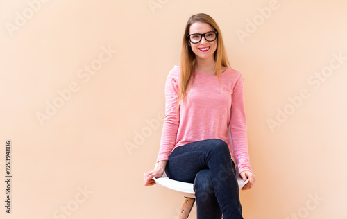 Happy young woman smiling while sitting in a big open room