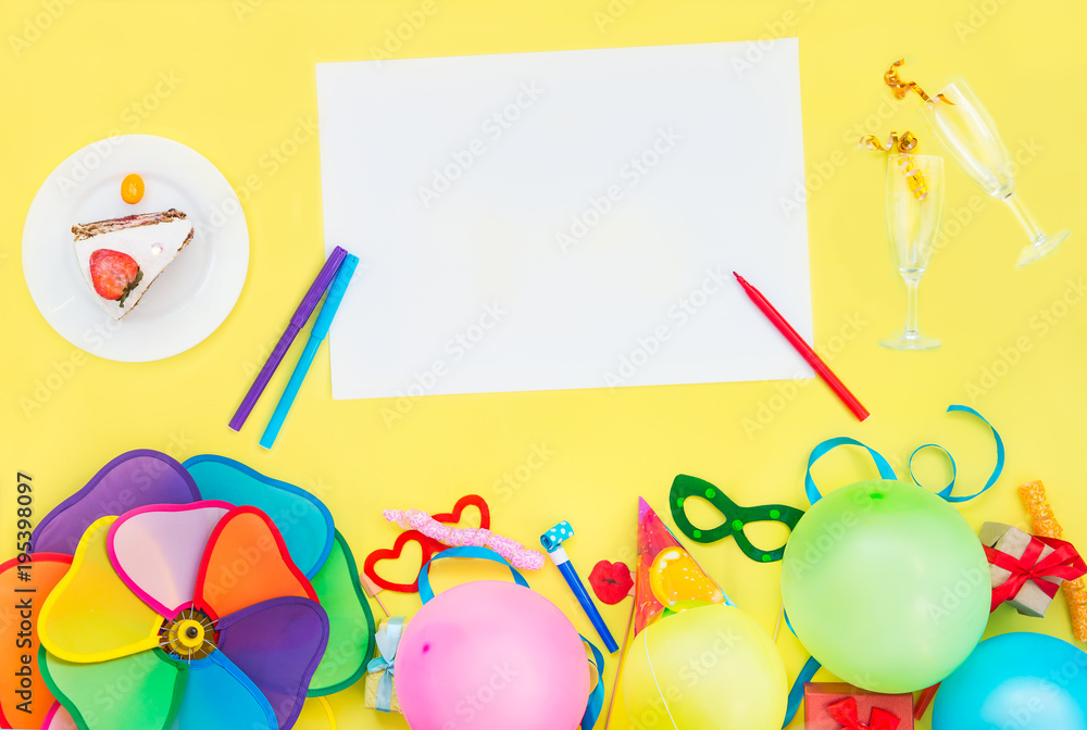Bright yellow background with festive cake, empty blank and champagne glasses with confetti ribbons, party tools and decoration. Happy birthday design concept. Place for text. Top view. Bright yellow background with festive cake, empty blank and champagne glasses with confetti ribbons, party tools and decoration. Happy birthday design concept. Place for text. Top view.