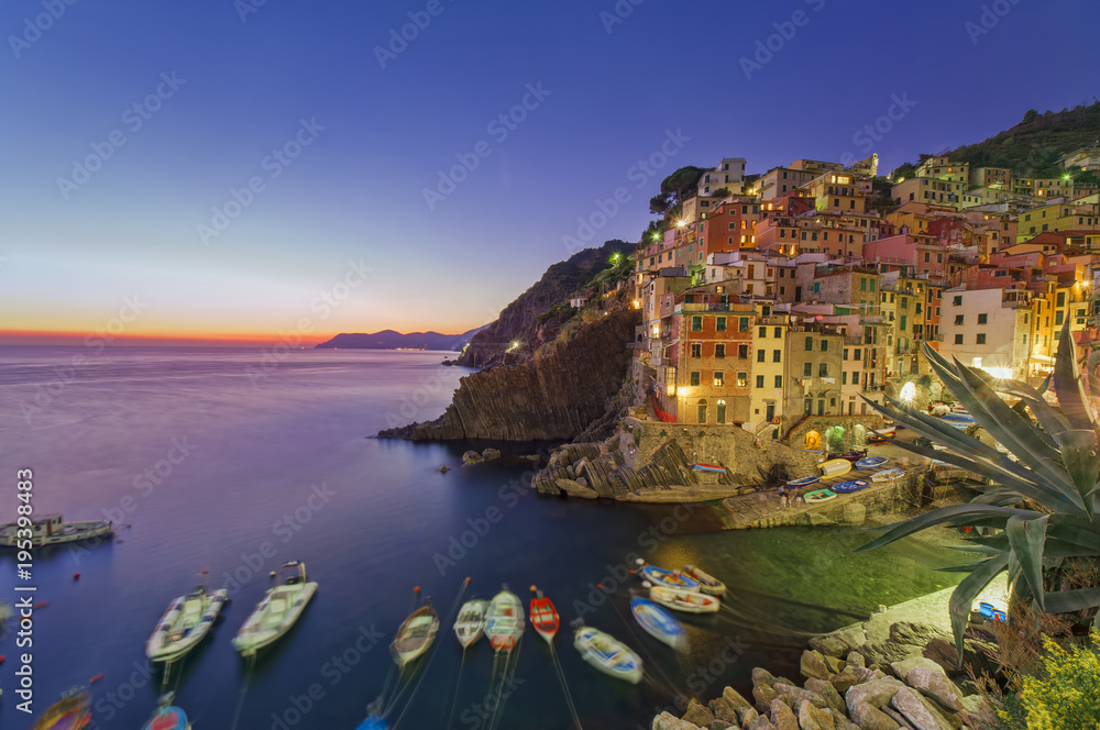 beautiful summer sunset at Riomaggiore fishing village from Cinque Terre, Italy