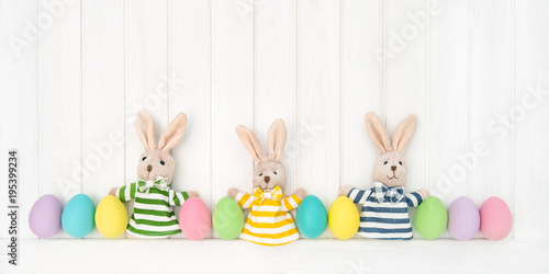 Easter decoration eggs funny bunnies wooden background