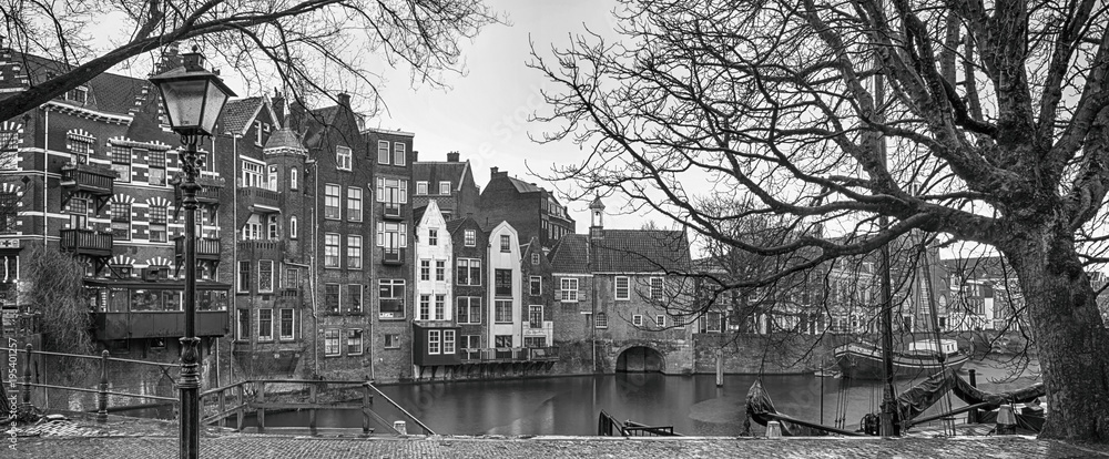 Obraz premium Cityscape, black-and-white panorama - view of the city Rotterdam and its old district Delfshaven, South Holland, The Netherlands