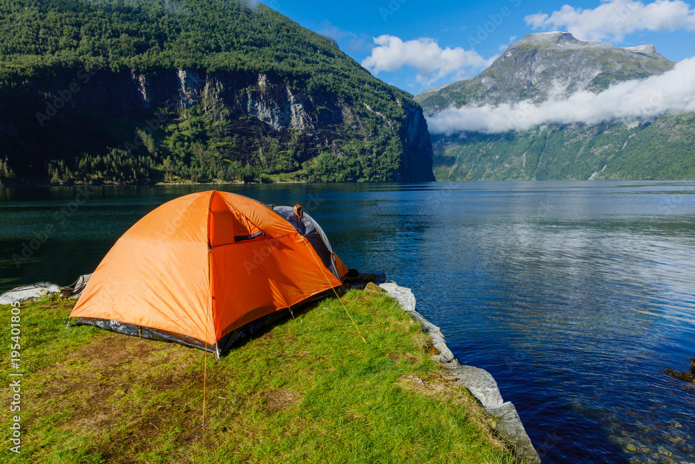 Norwegian fjord landscape with camping tent. Norway adventure.
