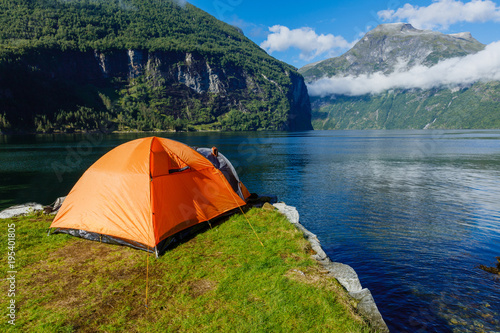 Norwegian fjord landscape with camping tent. Norway adventure.