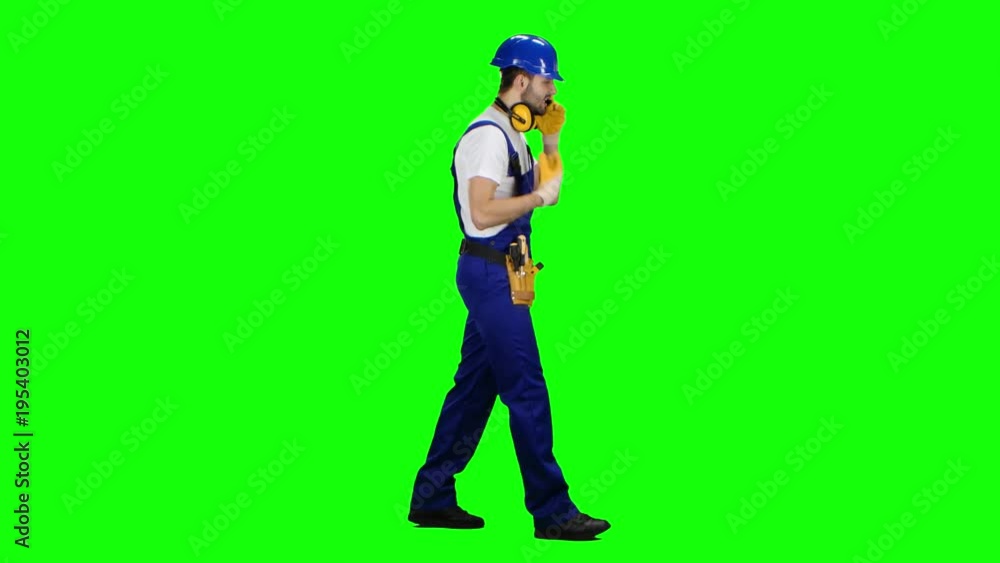 Builder speaks on the phone and screams at his subordinates. Green screen. Side view Builder speaks on the phone and screams at his subordinates. Green screen. Side view