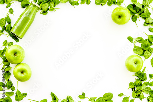 Green vegetables background with vegetable smoothies. Fresh apples, arugula salad on white background top view copy space